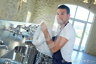 Worker cleaning barrel beer at brewery Stock Photo