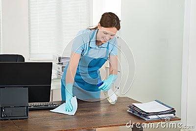 Worker Cleaning Desk With Rag Stock Photo