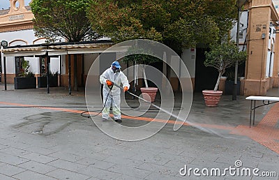 A worker of the cleaning and disinfection brigade seen during the COVID-19 outbreak in the island of Mallorca wide view Editorial Stock Photo