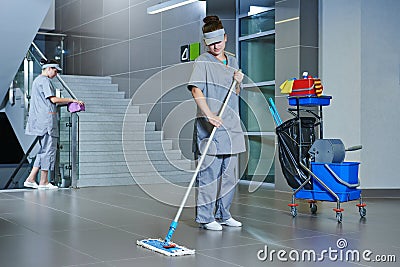 Worker cleaning floor with machine Stock Photo