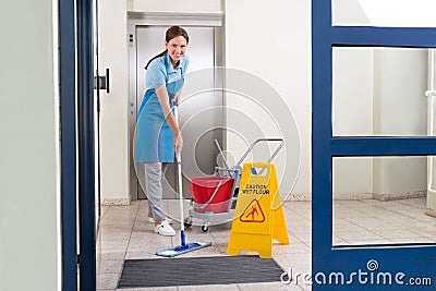 Worker Cleaning Floor With Mop Stock Photo