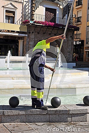 Worker cleaning an ornamental fountain in Ciudad Real, Spain Editorial Stock Photo