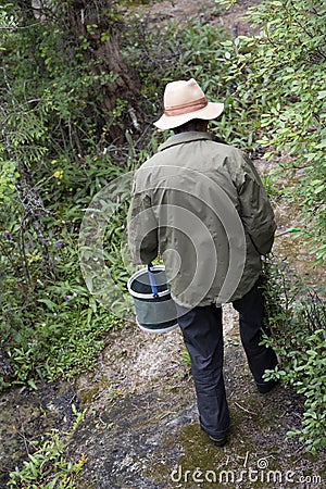 Worker cleaning trash on the mountain Editorial Stock Photo