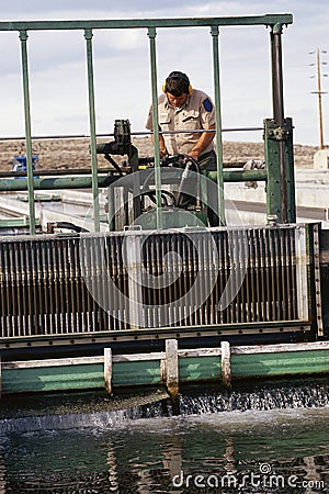Worker cleaning water Editorial Stock Photo