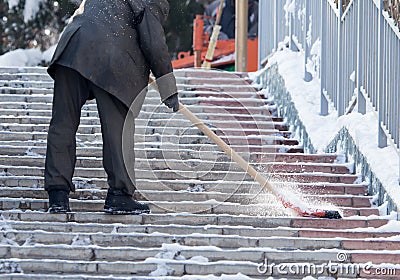 Worker cleans snow shovel in the nature Editorial Stock Photo