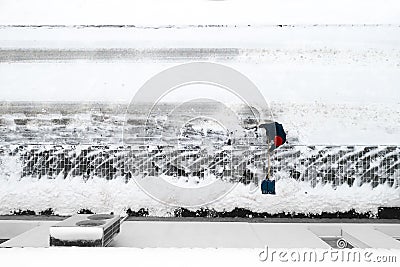 Worker cleans snow with a shovel top view Stock Photo