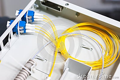 Worker comunicate fiber optic cable at opto box. installing new network equipment Stock Photo