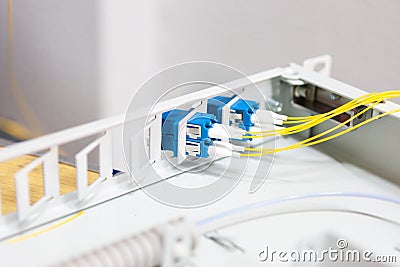 Worker comunicate fiber optic cable at opto box. installing new network equipment Stock Photo