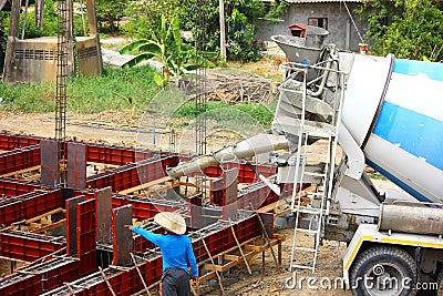 Worker with concrete Mixer machine Editorial Stock Photo