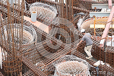 Worker in the construction site near the armatures Stock Photo