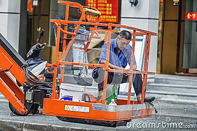 Worker on the construction vehicle Editorial Stock Photo