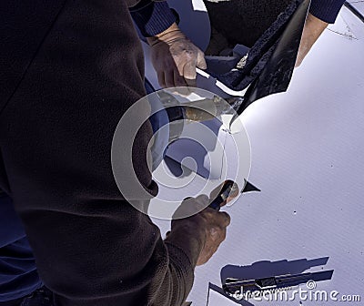 Worker cut and weld heat PVC sheet Stock Photo