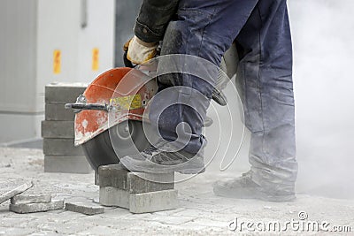Worker cutting the brick pavers Stock Photo