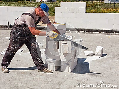 Worker cutting concrete blocks Stock Photo