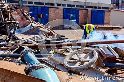 Worker is cutting scrap metal with acetylene torch Stock Photo