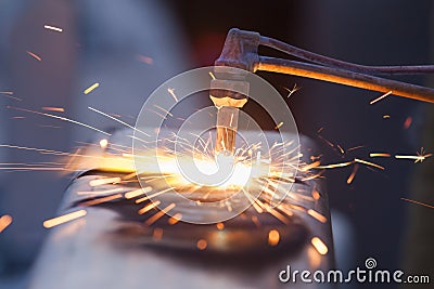 Worker cutting steel pipe using metal torch and install roadside Stock Photo