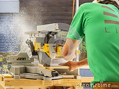 Worker cutting strips with machinery Editorial Stock Photo