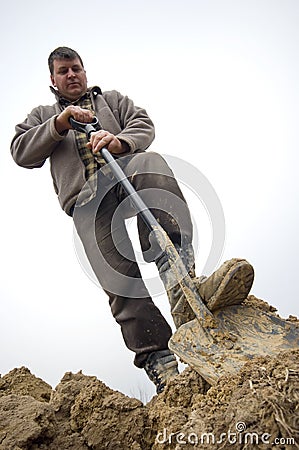 Worker digging in the ground Stock Photo