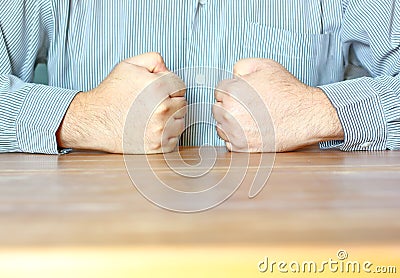 The worker doing double handful on table in front of his breast Stock Photo