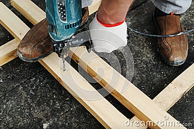 Worker drill holes Stock Photo