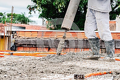 Worker dumping concrete over the slab Stock Photo