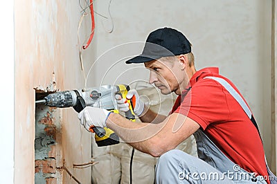 Worker with an electric hammer. Stock Photo