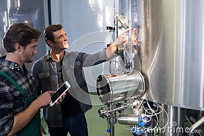 Worker explaining to coworker using tablet computer Stock Photo