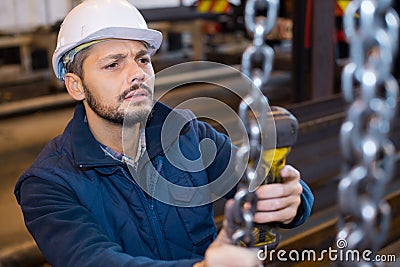 Worker in factory with hand lift Stock Photo