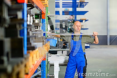 Worker in factory in stockroom Stock Photo