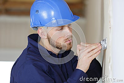 Worker filling wall with putty Stock Photo