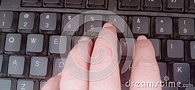 Worker finger typing on keyboard Stock Photo