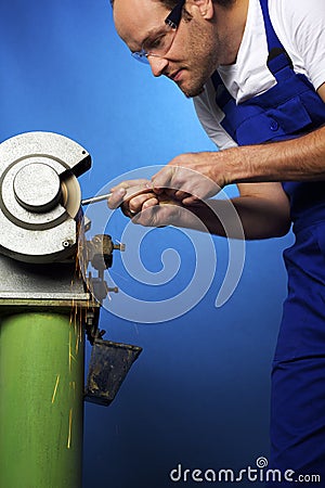 Worker on grinding bench Stock Photo