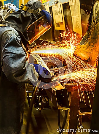 Worker grinding metal Stock Photo