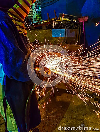 Worker grinding metal Stock Photo