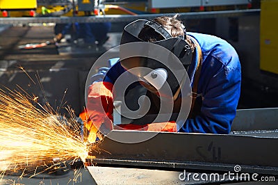 Worker grinding/welding Stock Photo