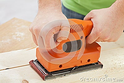 Worker hands with electric sander machine Stock Photo