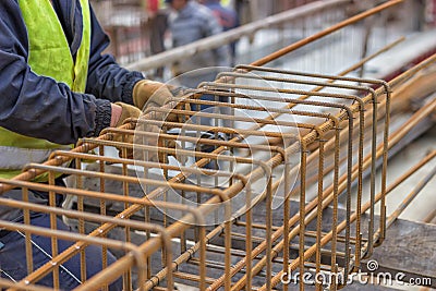 Worker hands fixing steel reinforcement bars Stock Photo