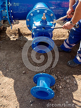 Worker hands screwing nuts on new dring water piping. Stock Photo