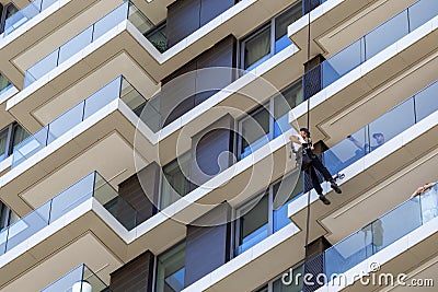 Worker hanging on climbing rope Editorial Stock Photo