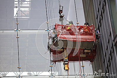 Worker high in the air on a Lift Platform at a Construction Site of a new Skyscraper in New York City Editorial Stock Photo