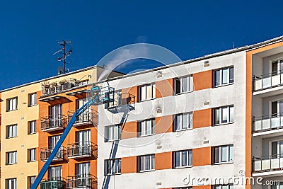 Worker with high pressure washer cleaning house facade Stock Photo