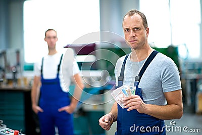 Worker with his wages Stock Photo