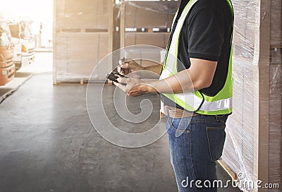 Worker is Holding A Smartphone and Communicating with A Customer. Delivery Sevice. Shipment Package Boxes. Warehouse Logistics. Stock Photo