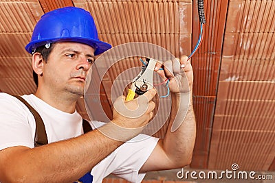 Worker installing electrical wiring Stock Photo