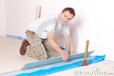 Worker installing a laminated flooring Stock Photo