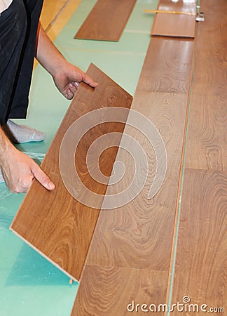 Worker installing new laminate flooring Stock Photo