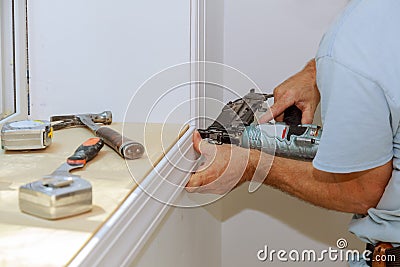 Worker installing trim around a window Stock Photo