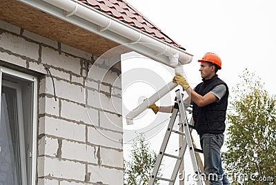 Installation of gutter system Stock Photo
