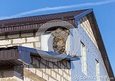 Worker insulates the walls of the house with plastic panels Stock Photo