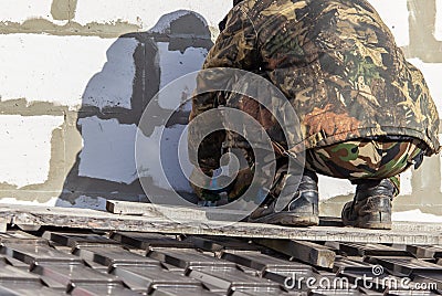 Worker insulates the walls of the house with plastic panels Stock Photo